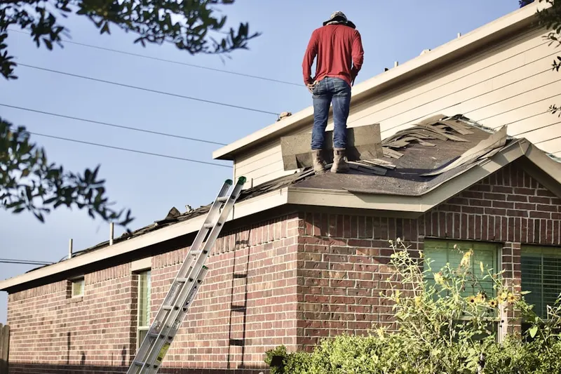 Professional roofer working on a residential roof in Crescent Park